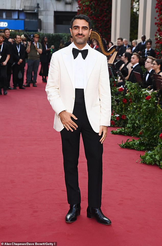 Stylish: GQ Magazine deputy editor Adam Baidawi opted for a cream-colored blazer with a large bow tie