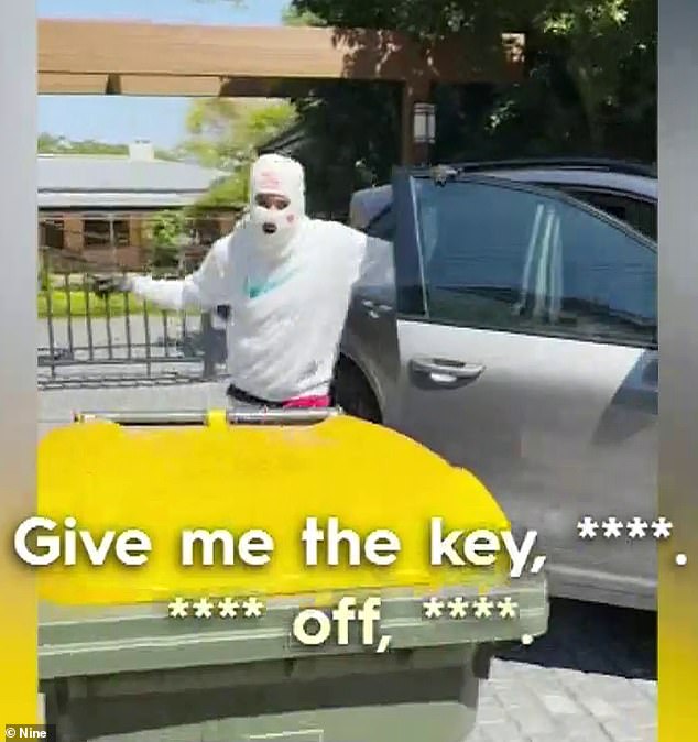 The video shows a man in a white balaclava demanding Connor to give him the 'fucking keys c***' after he manages to grab them from a Porsche in the driveway (pictured)