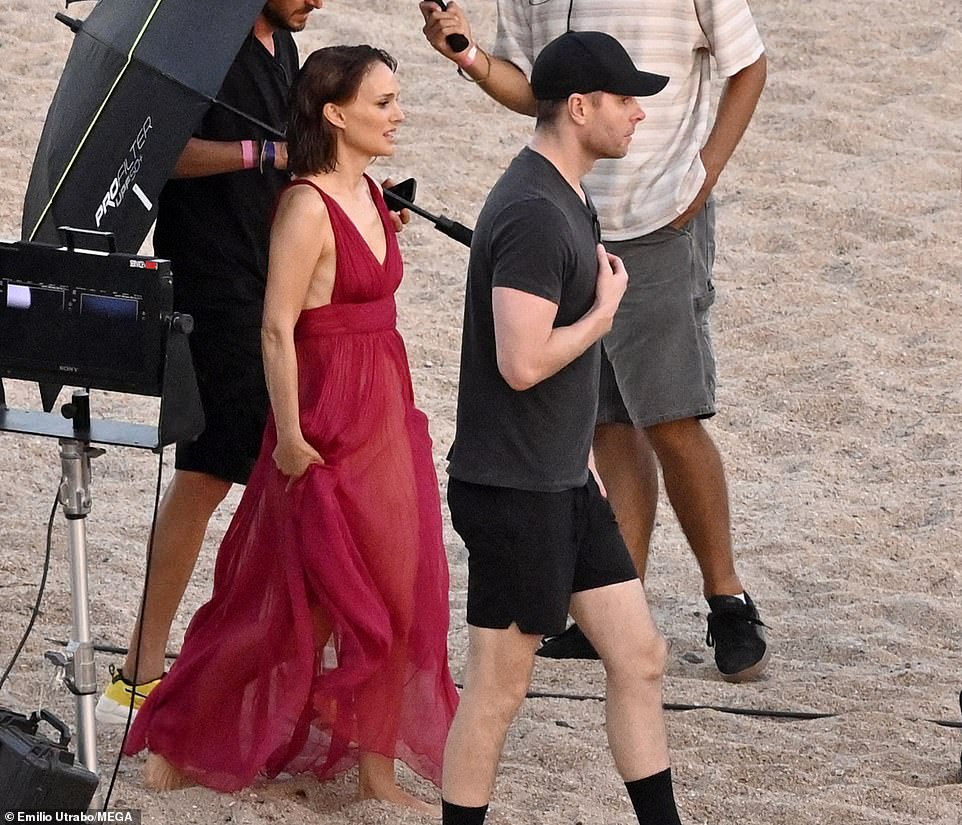 Strolling in the sand: She was also seen strolling in the sand with the production team by her side