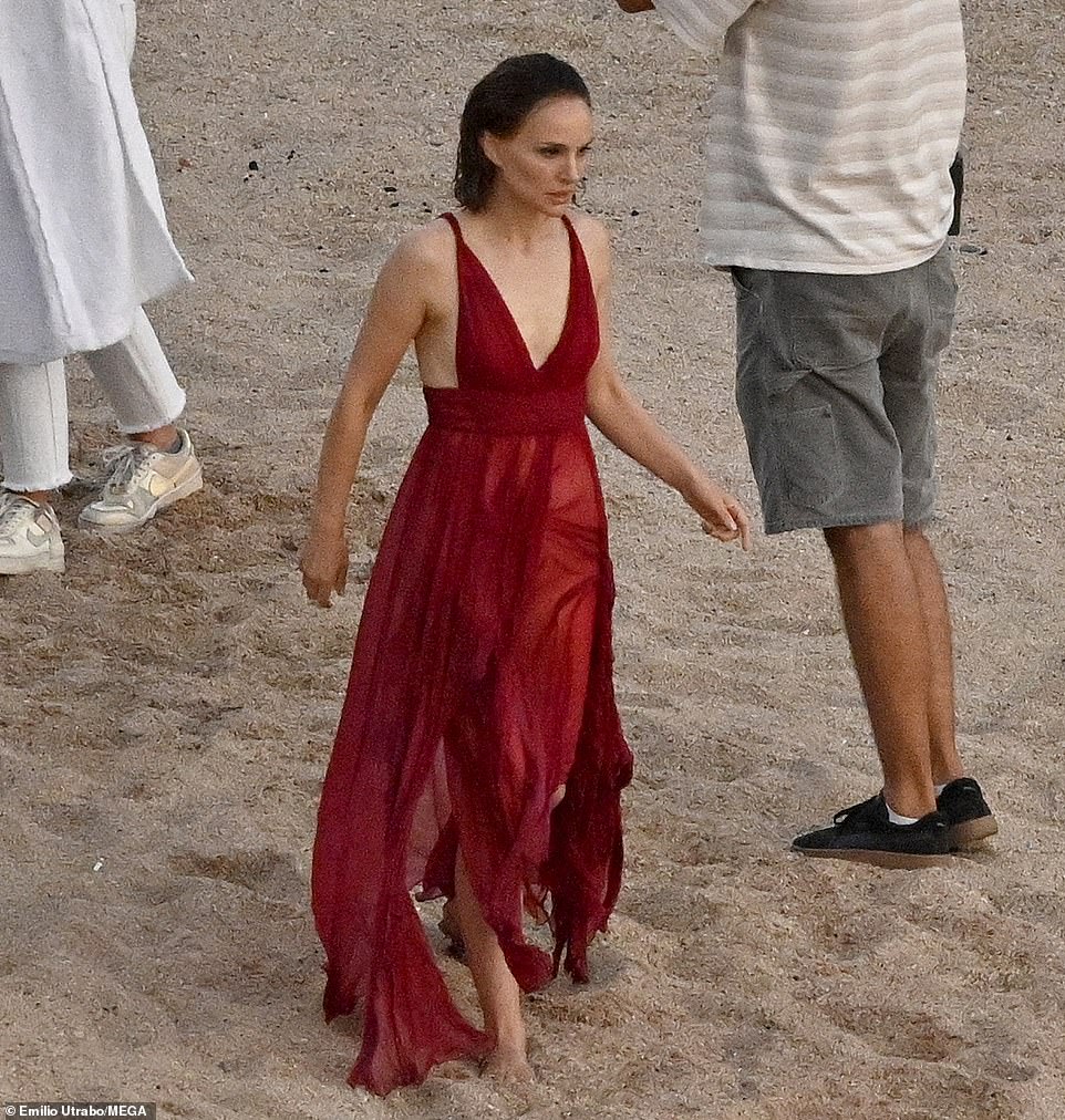 Another shot: She is seen walking back to the water several times, still in the now wet dress, to re-film the scene