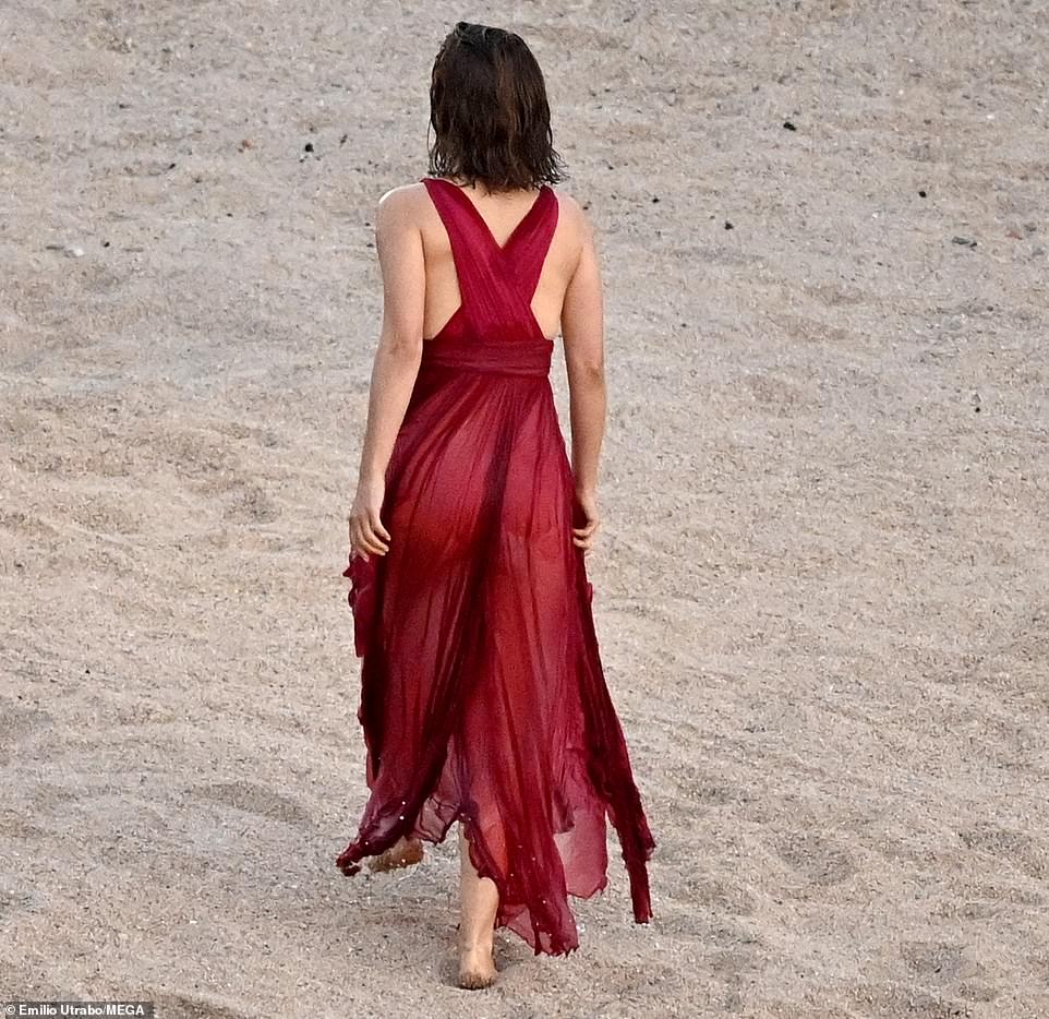 From the back: the beautiful designer dress hugged her figure well