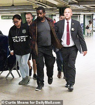 Mills was walked through New York's Union Station by a group of law enforcement officers on Thursday evening