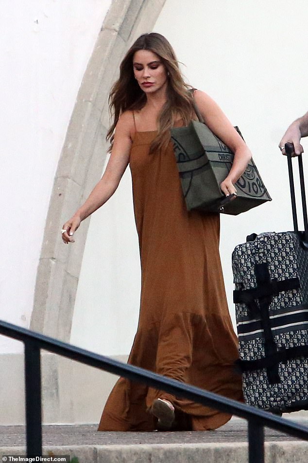 Relaxed fit: The actress, 51, donned a flowing brown summer maxi dress and sandals and carried a large Christian Dior bag over her shoulder