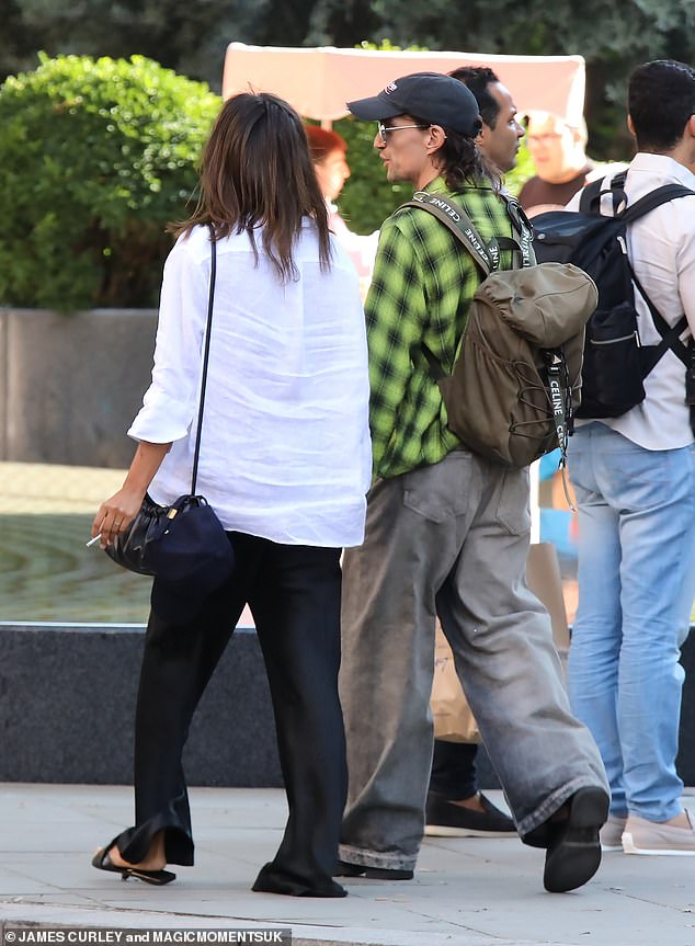 Holding hands: The couple looked completely at ease in each other's company as they chatted before stopping at a coffee shop