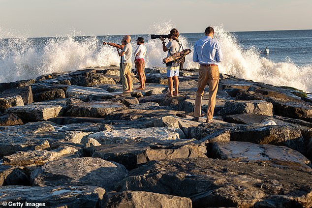 Surfers and others spend a day at Rockaway Beach as the impact of Hurricane Lee brings large surf and tidal waves to much of the Northeast on September 14, 2023 in New York City