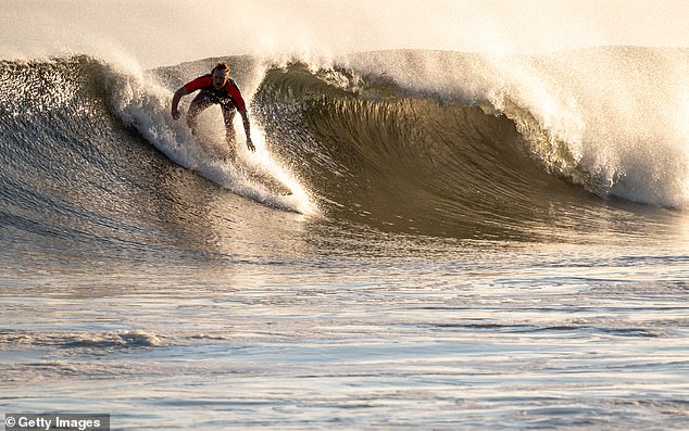 Surfers spend a day at Rockaway Beach as the impact of Hurricane Lee in New York City on September 14, 2023 brings large surf and tidal waves to much of the Northeast.  Anyone found in the water in New Jersey starting Friday will be fined