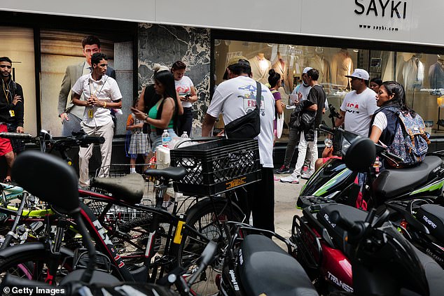 Recently arrived migrants gather outside the Roosevelt Hotel in New York City on August 14, 2023 in New York City