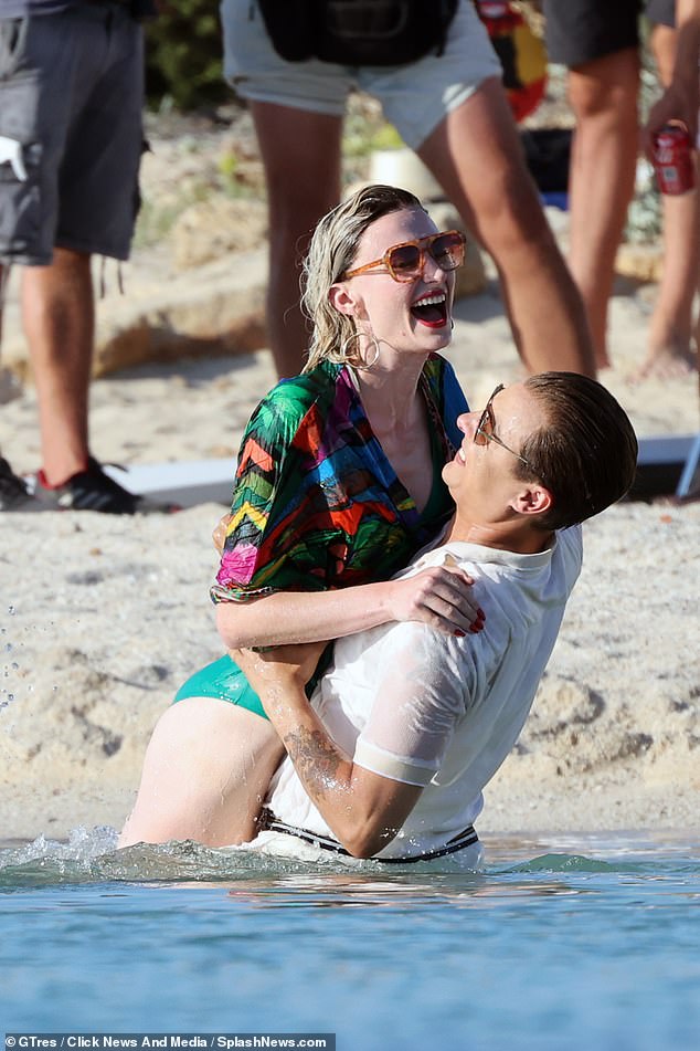 On set: Sophie had a big smile on her face as she frolicked in the water with Frank