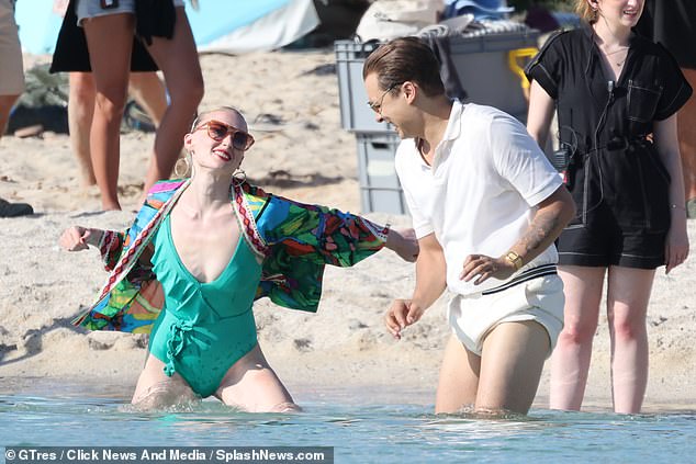 Beach: Sophie, with wet hair, wore a brightly patterned top over her swimsuit