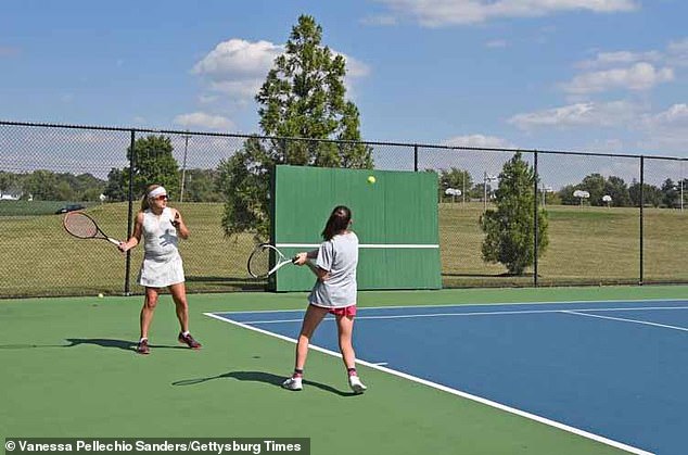 Yates (left) was back on the field after being reinstated as head coach.  The girls tennis team started the season without a coach while the board decided on the contract