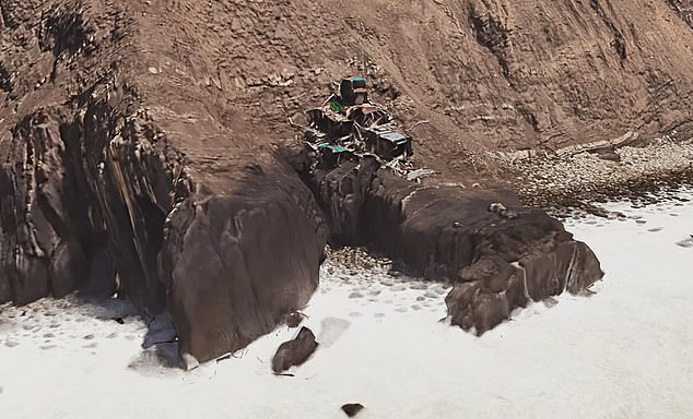 The drone footage shows waves just meters away from the base of the structure