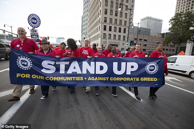 UAW President Shawn Fain marches with UAW members through downtown Detroit on Friday