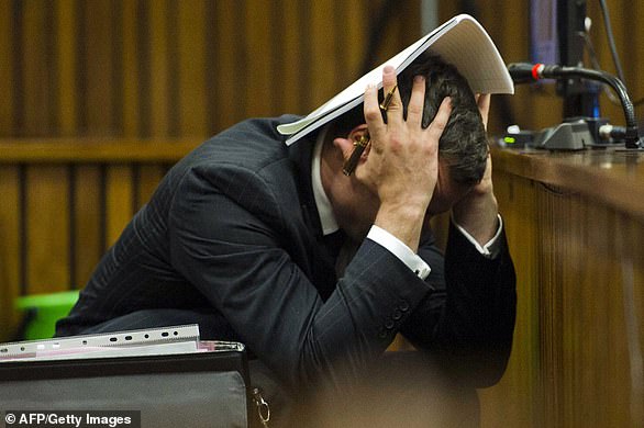 Oscar Pistorius holds his head in his hands during his murder hearing at the North Gauteng High Court in Pretoria, South Africa, on March 13, 2014