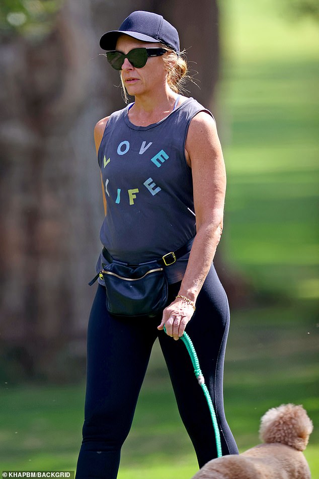 She showed off her fit physique in sporty black leggings and a tank top that said 