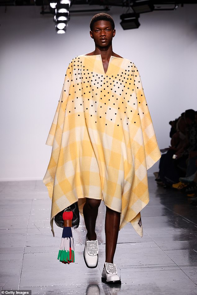 A design by Stefan Cook showed a yellow poncho dress complete with white studded loafers and a leather bag