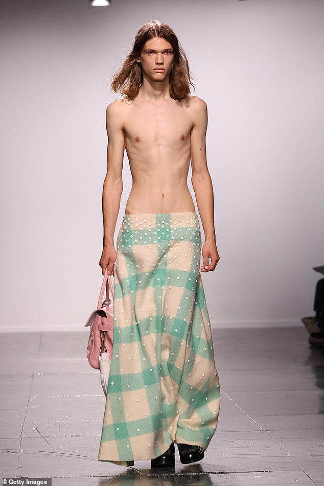 One model wore a plaid maxi skirt with studs and a pink leather bag, but nothing on the top half