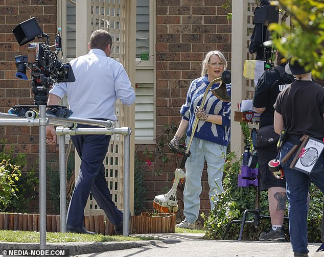 It looked like the actors were filming a scene in their fictional garden as cameras focused on Lucinda holding a snip as she played Melanie Pearson.