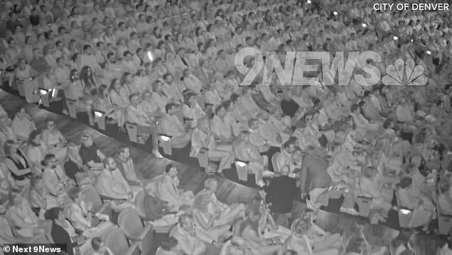 Security personnel are seen talking to the congressman and Gallagher inside the theater before escorting them out