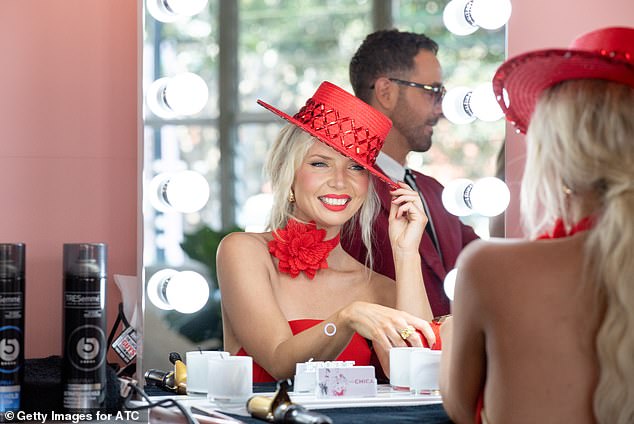 Her bright red nails and bold red lip matched the monochrome look