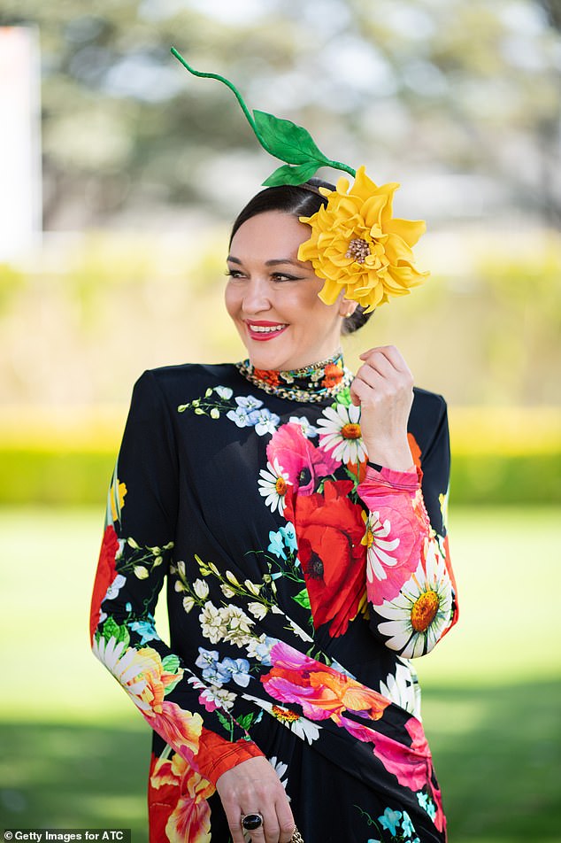 From poppies and daffodils to delicate daisies, Viera leaned into the colorful aesthetic with a bright yellow floral fascinator while clutching a Balmain handbag.