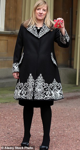 Designer Sarah Burton with her Officer of the British Empire (OBE) medal after an investiture ceremony at Buckingham Palace