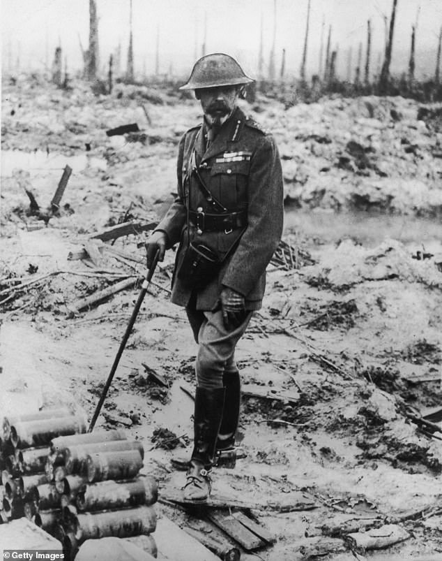 The Queen's grandfather, George V, in military uniform looks at a battlefield in France in 1914