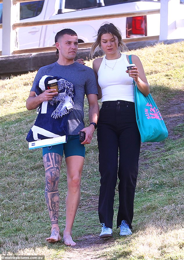 The couple carried takeaway coffee onto the lawn