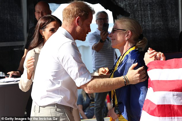 Harry and Meghan congratulate Yulia 'Taira' Paievska during the swimming medals ceremony during day seven of the Invictus Games in Dusseldorf 2023 on September 16, 2023