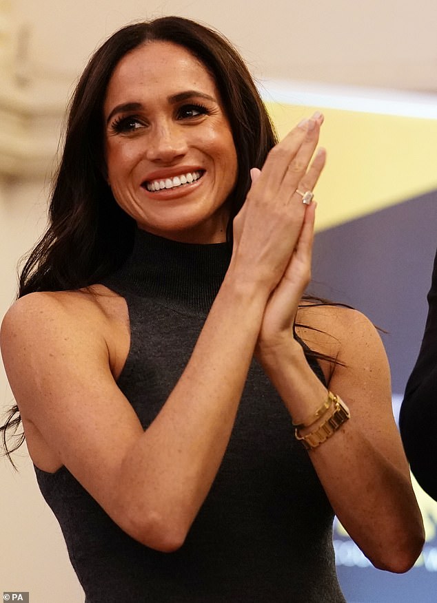 Meghan Markle (pictured) stunned in a gray dress as she attended the Team Canada meeting at the Invictus Games this afternoon