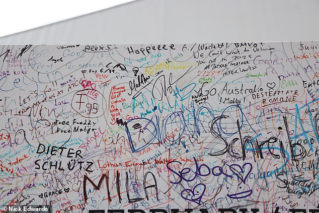 The sign appears to be full of colorful signatures, congratulations and encouragement from those attending and participating in the competition