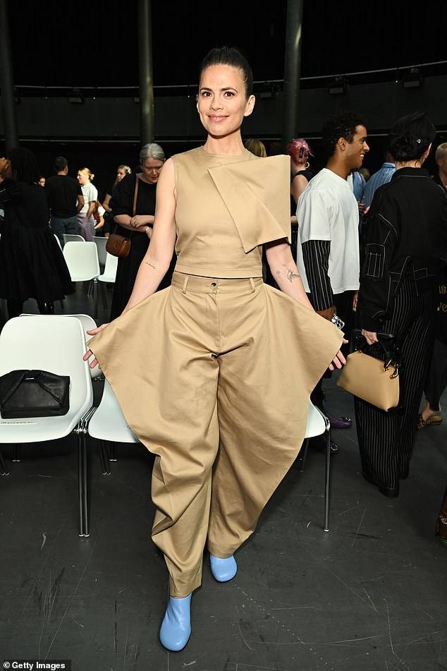 Stylish: She chose to combine the stylish top with extravagant beige trousers with a high waist