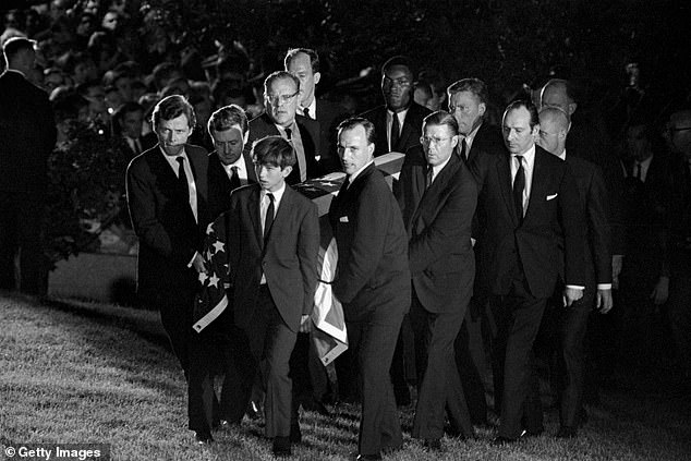 Pallbearers (including Robert F. Kennedy Jr.'s front) carry Senator Robert Kennedy's casket to the grave at Arlington National Cemetery on June 9, 1968