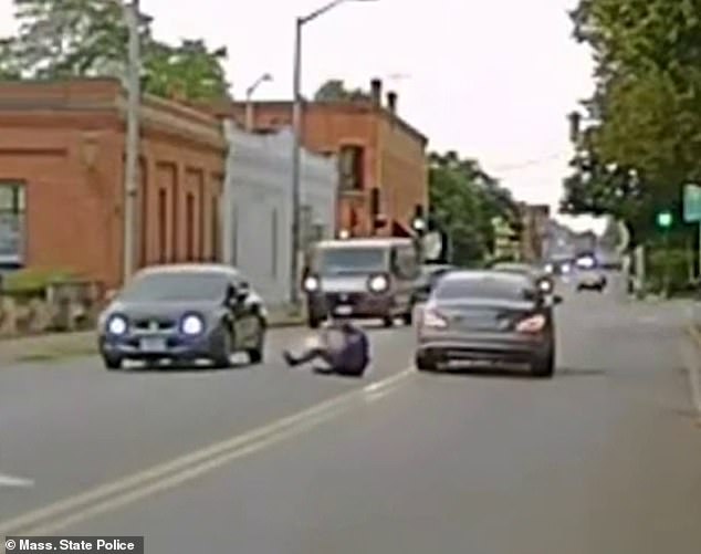 About ten meters away, the officer is forced to release his grip and is thrown into oncoming traffic.  He escaped with minor injuries