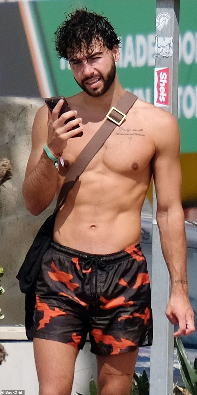 Abs galore: Earlier in the day, Sammy went shirtless and put on a pair of camouflage swim shorts