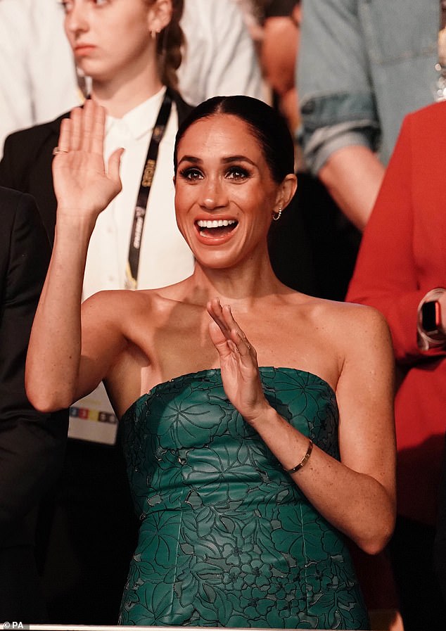 Meghan was seen waving during the ceremony, which saw the US team take to the stage for Bruce Springsteen's iconic hit Born In The USA