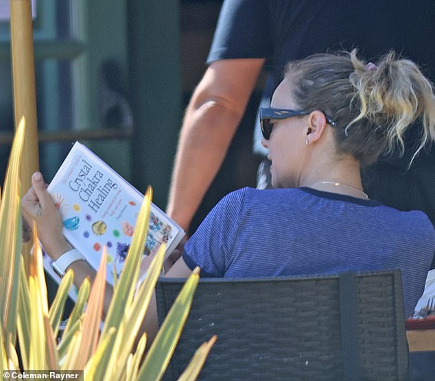 The photos, taken shortly after the actor's arrest, show Bijou reading the book near her home in Santa Ynez.