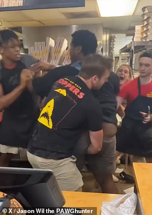 The group of employees tries to pin the man down