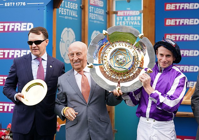 Aidan O'Brien (L) and jockey Ryan Moore (R) celebrate winning the last classic of the season