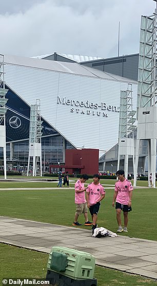 Fans stand outside Mercedes-Benz Stadium in Atlanta, wearing their Inter Miami Messi jerseys