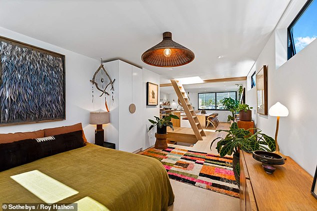 The bedroom also has plenty of natural light, wooden furniture and clean lines