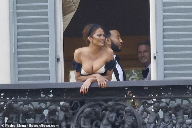 Balcony: She wore her hair in an updo with a black headband and wore diamond earrings as they exchanged their vows and later posed on a balcony as a royal couple