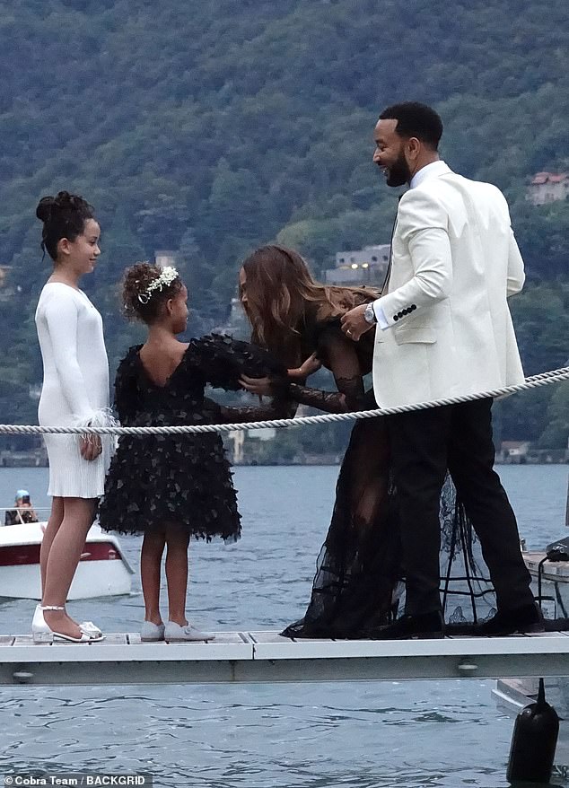 Lakeside life: The mother of four looked stunning in a floor-length black dress with long sleeves and sheer patches on the sleeves, torso and skirt