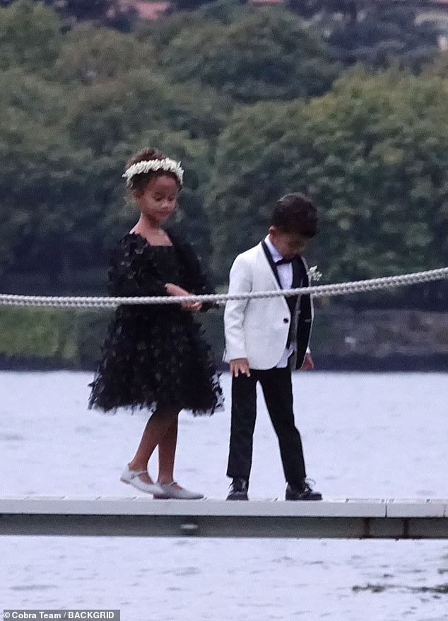 Kids: The couple's daughter Luna, seven, looked adorable in a knee-length black textured dress.  Their eldest child had her hair up and wore a white flower crown.  Their son Miles, five, wore a miniature version of his father's tuxedo