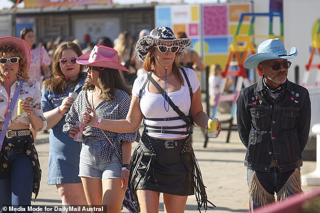 Sunglasses, hats and liquid refreshments: these revelers were all prepared for the day ahead