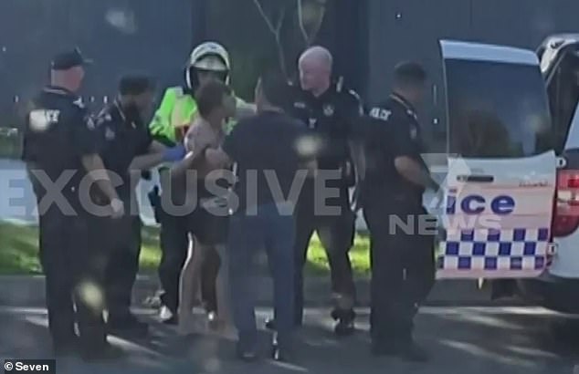 Dramatic footage later emerged of Sefton-Bennett (pictured center) reportedly fleeing the scene on foot and being apprehended by officers, including one who held the accused driver by the throat.