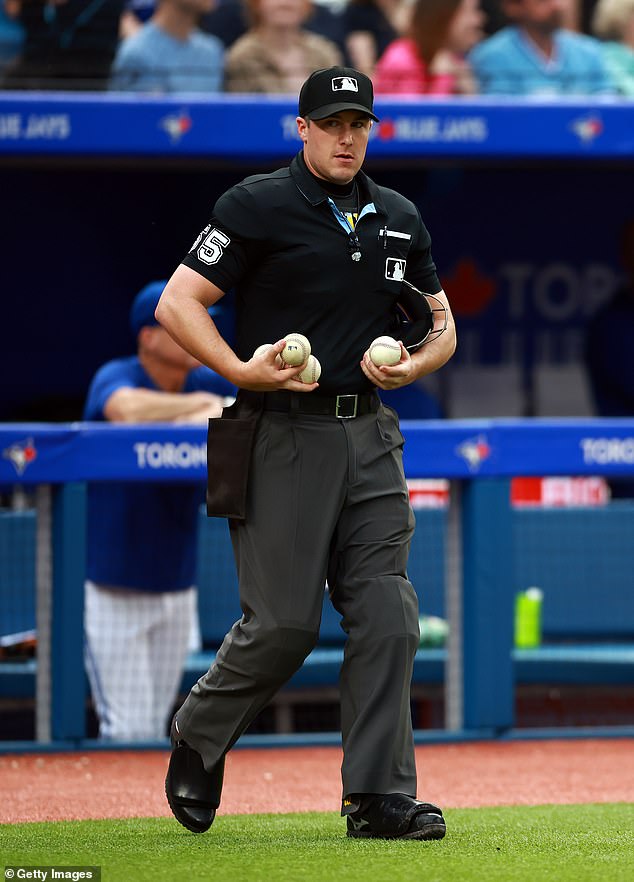 Umpire Brennan Miller takes over home plate umpire duties after Jordan Baker leaves the game