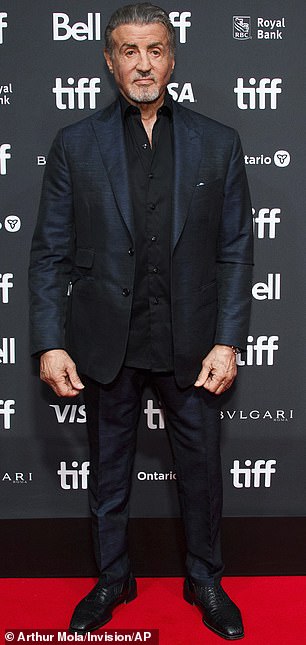 Stylish: Stallone opted for a navy blue jacket and matching tight-fitting trousers at the event