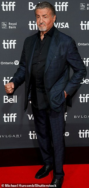 Stylish: Stallone opted for a navy blue jacket and matching tight-fitting trousers at the event