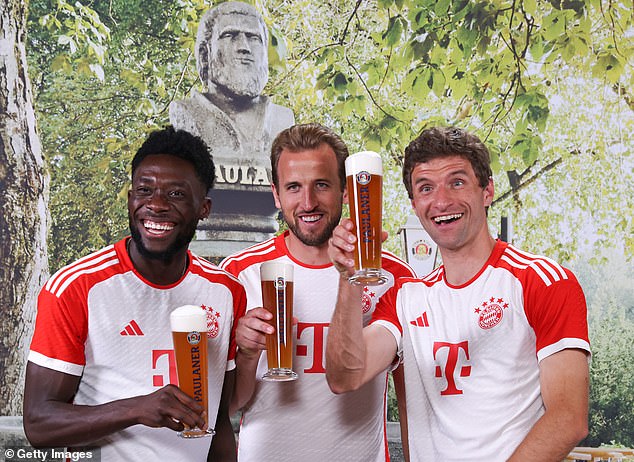 Kane, Alphonso Davies (left) and Thomas Muller (right) raise a glass during the annual promotional photo shoot for brewer Paulaner