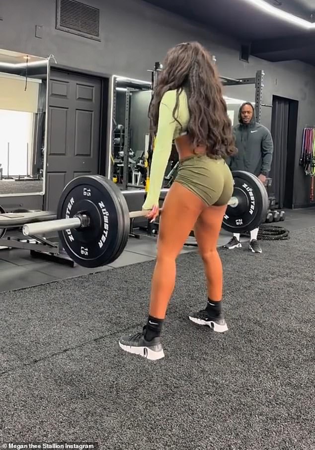 Going green: The music artist showed off her toned derriere as she went through a heavy deadlift